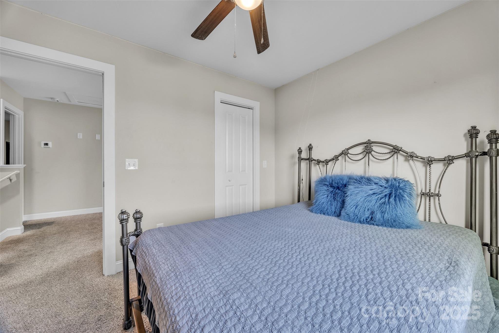 2510 Snow Creek Road Northeast Hickory, NC 28601 - Photo 23 of 45 a bedroom with a large bed and a chandelier