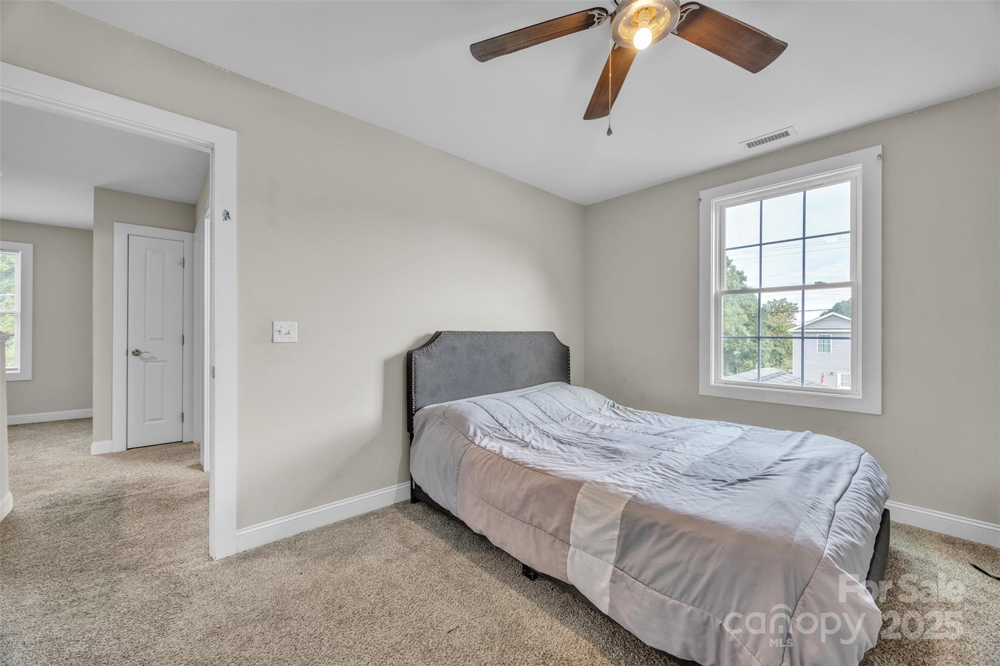 2510 Snow Creek Road Northeast Hickory, NC 28601 - Photo 26 of 45 a bedroom with a bed and a chandelier