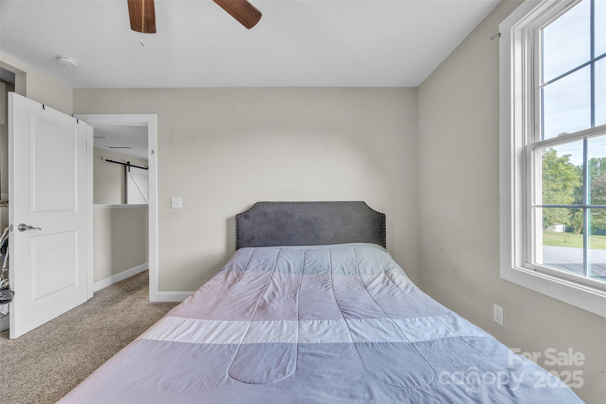 2510 Snow Creek Road Northeast Hickory, NC 28601 - Photo 27 of 45 a bed sitting in a bedroom next to a window