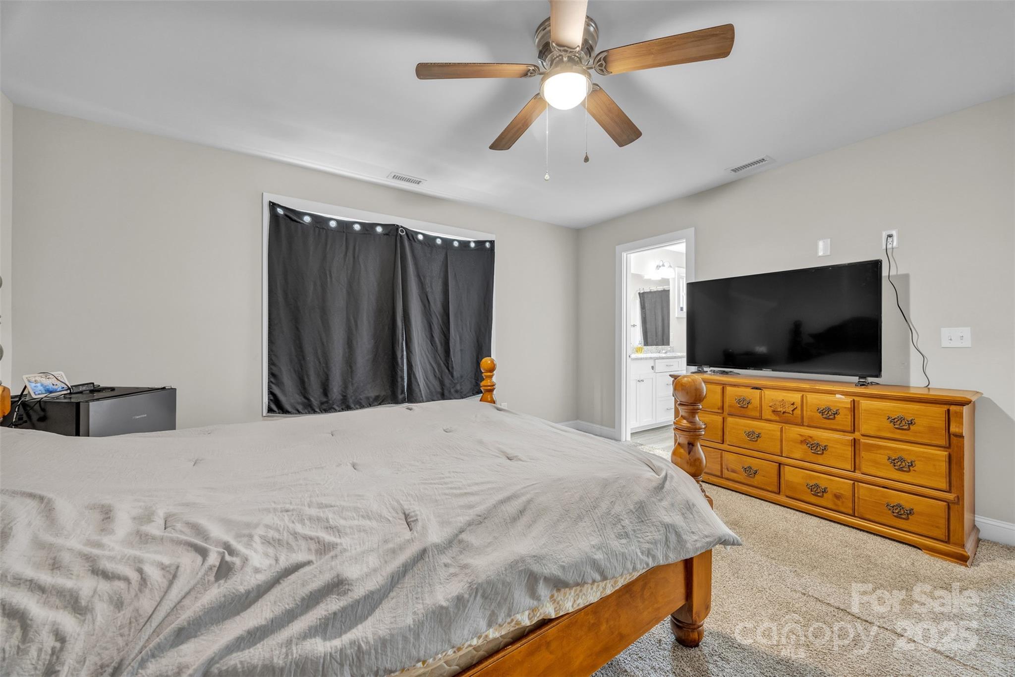 2510 Snow Creek Road Northeast Hickory, NC 28601 - Photo 30 of 45 a bedroom with a bed and a flat screen tv