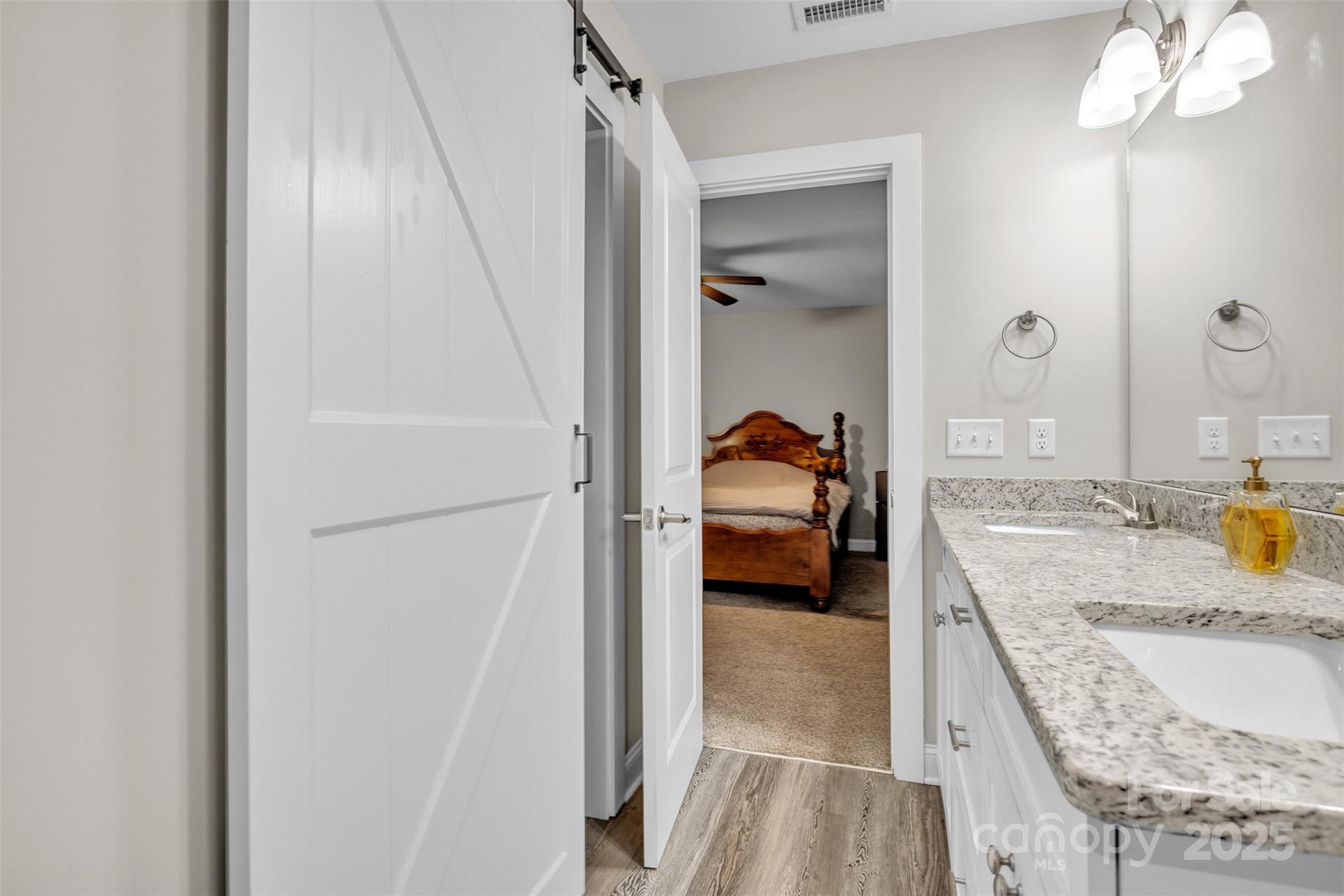 2510 Snow Creek Road Northeast Hickory, NC 28601 - Photo 33 of 45 a en suite bathroom with a granite countertop sink and a tub