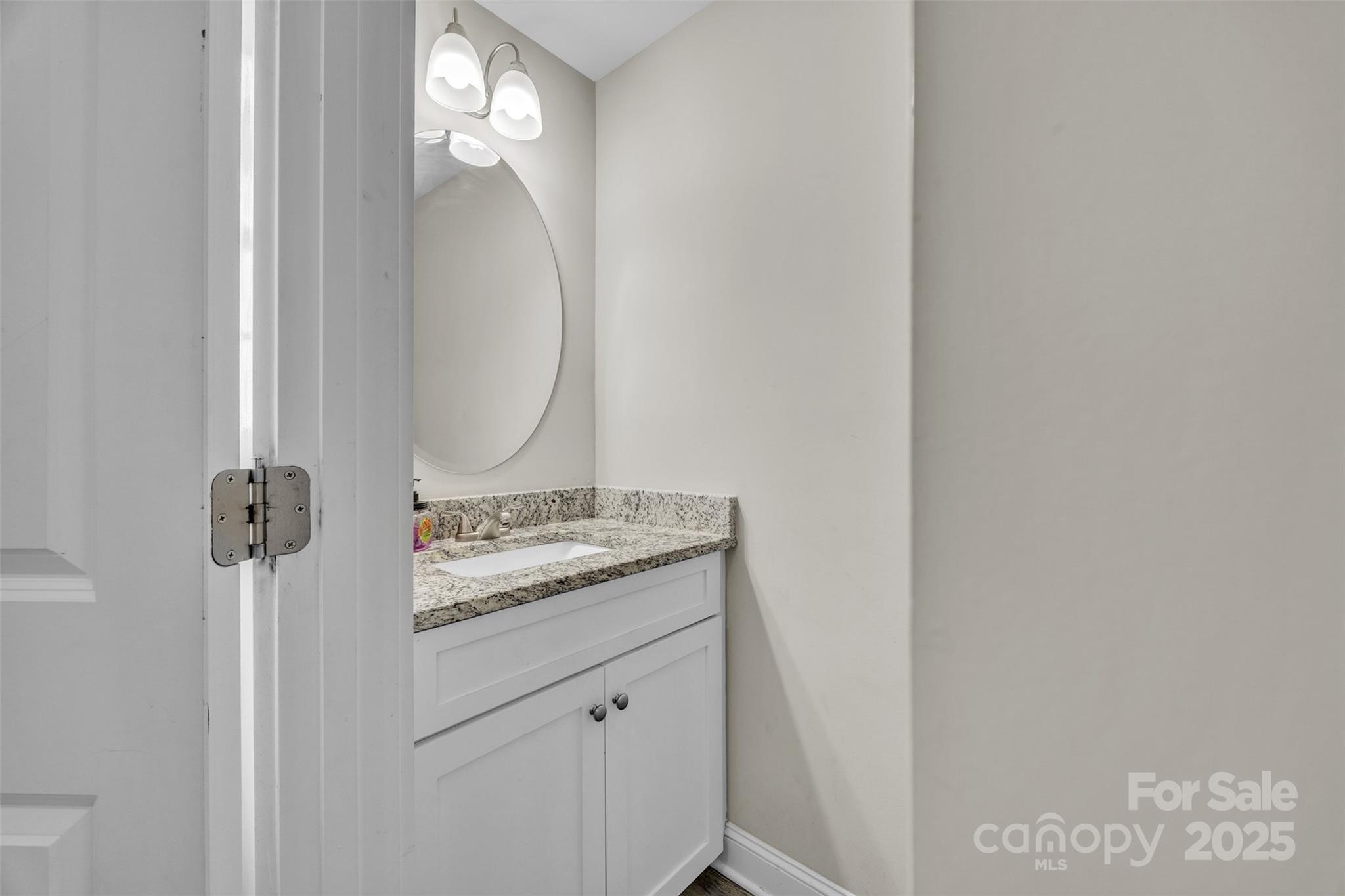 2510 Snow Creek Road Northeast Hickory, NC 28601 - Photo 6 of 45 a bathroom with a granite countertop sink and a mirror