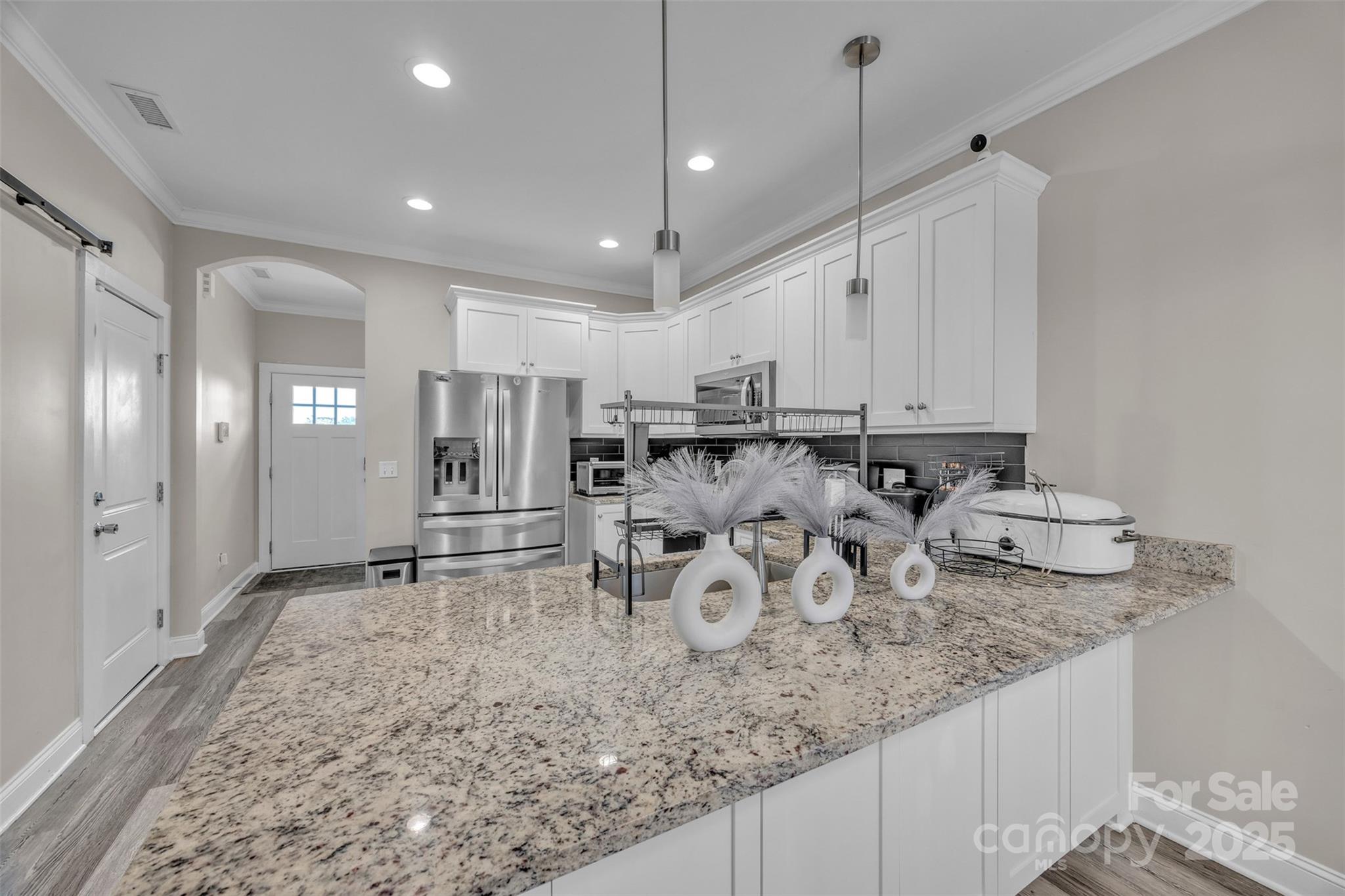 2510 Snow Creek Road Northeast Hickory, NC 28601 - Photo 8 of 45 a kitchen with white cabinets and stainless steel appliances