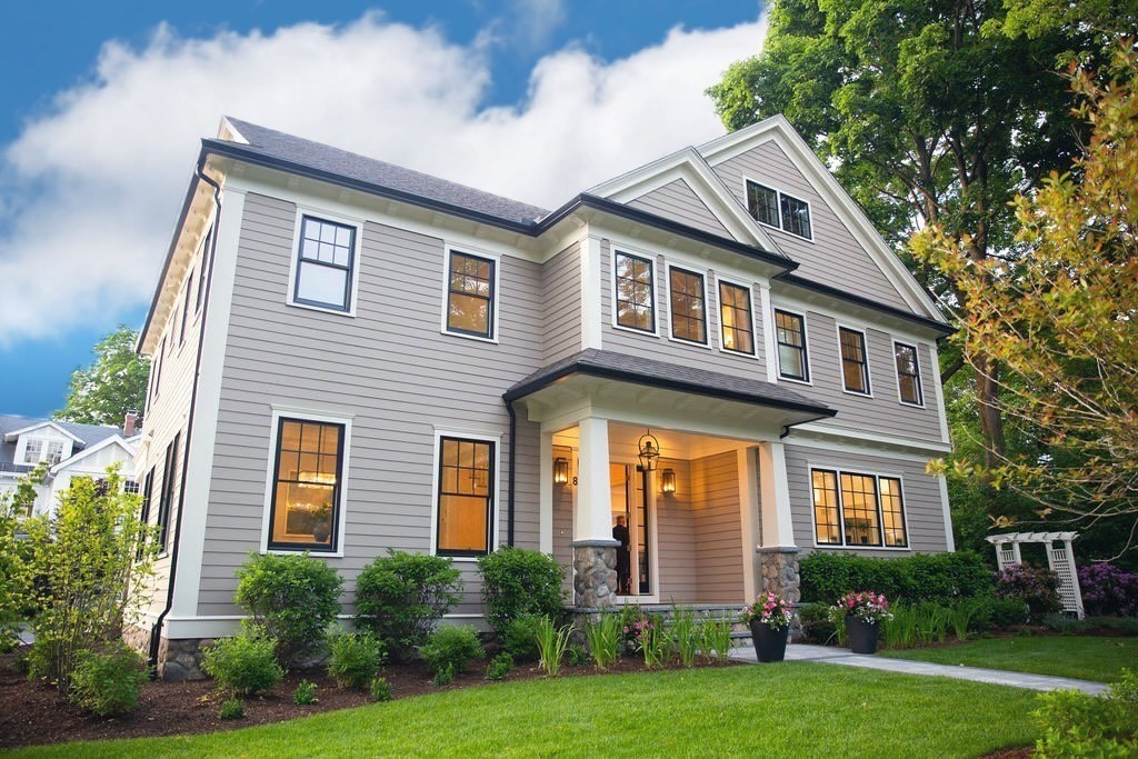 a front view of a house with a yard and trees