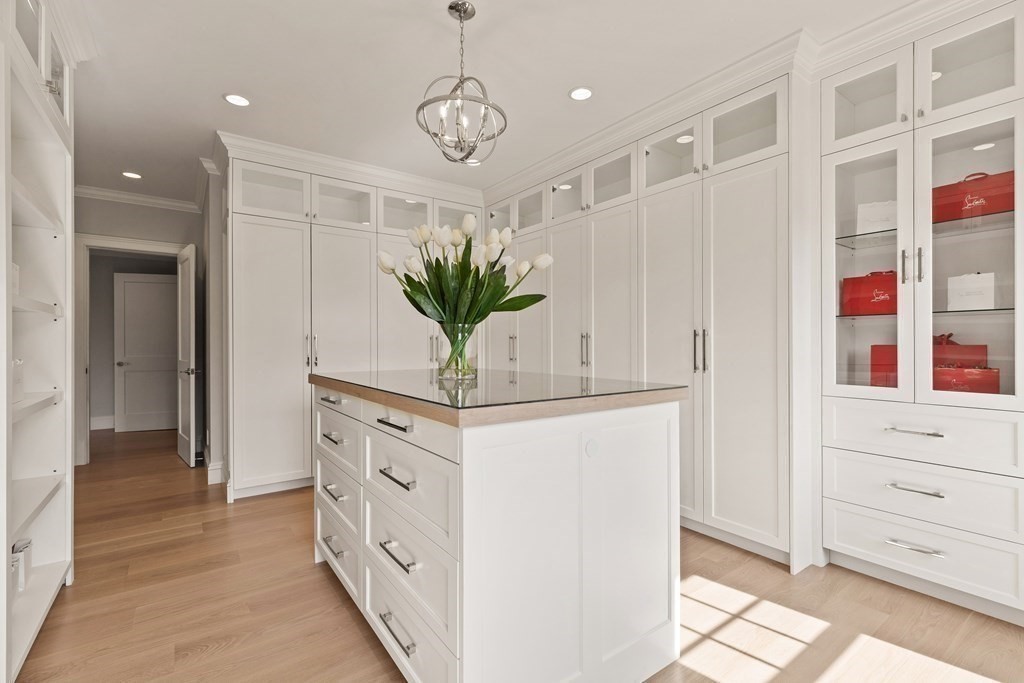 8 Hayes Avenue Lexington, MA 02420 - Photo 14 of 24 a hallway with white cabinets and chandelier