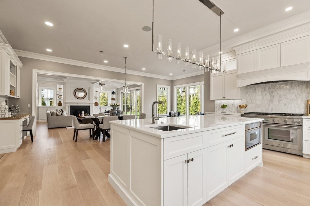 8 Hayes Avenue Lexington, MA 02420 - Photo 2 of 24 a large white kitchen with lots of counter space a sink appliances and dining table