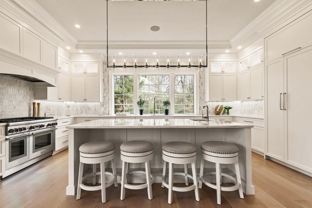 8 Hayes Avenue Lexington, MA 02420 - Photo 6 of 24 a kitchen with a dining table chairs sink and stove