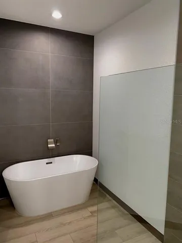 a white bath tub sitting in a bathroom