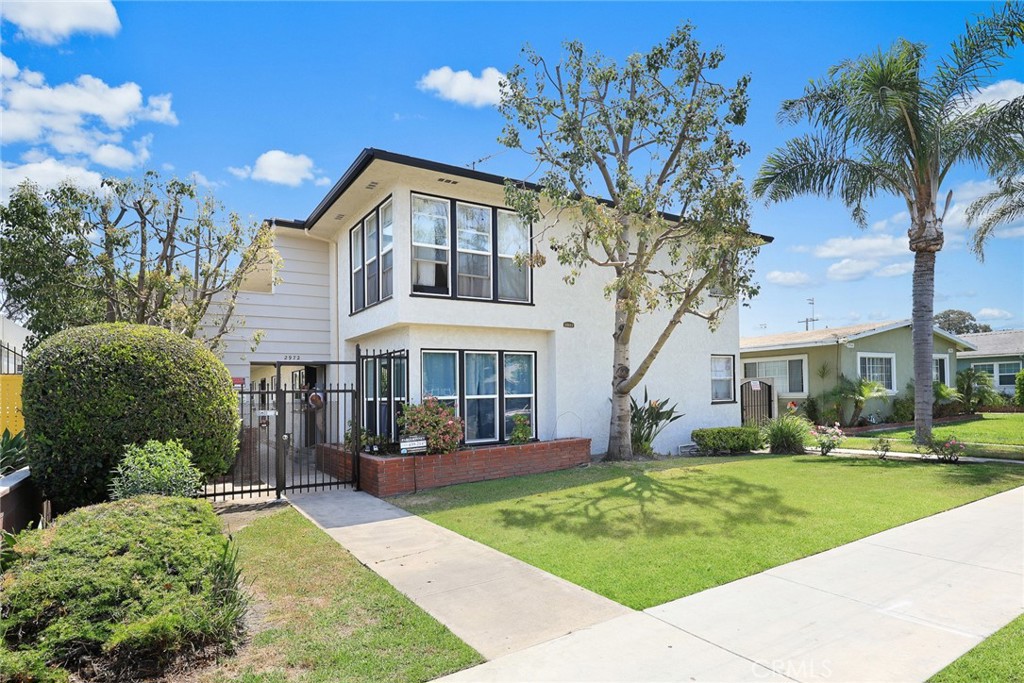 2972 Pacific Avenue, Unit A Long Beach, CA 90806 - Photo 1 of 26 a front view of a house with a yard