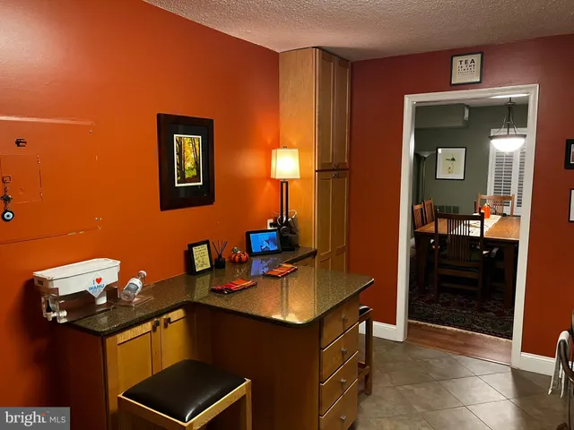 a living room filled with furniture and a potted plant