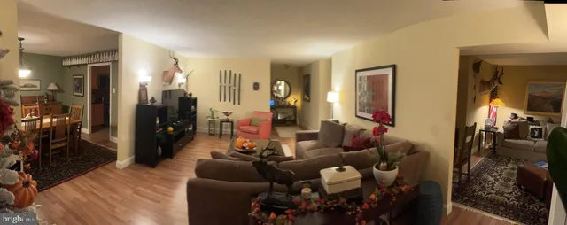 a blue couch sitting in a room next to a lamp