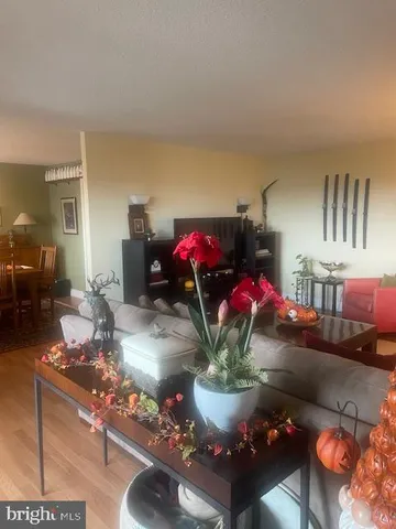 a living room with a couch and a table with wooden floor