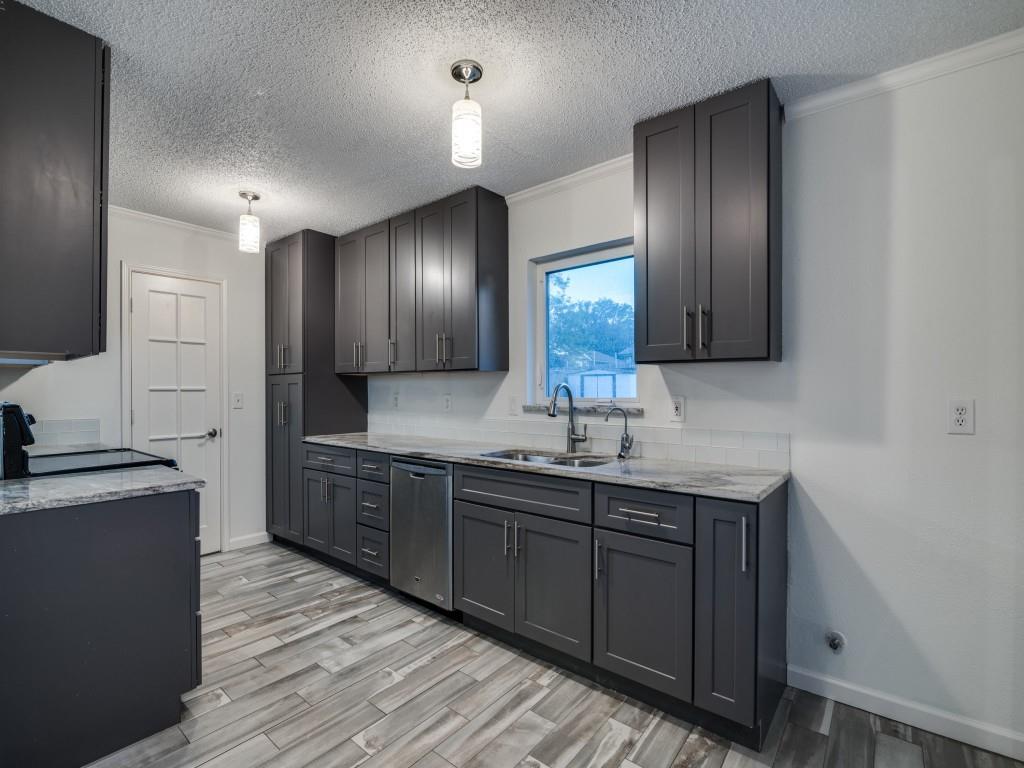 3425 Tarkio Road Plano, TX 75074 - Photo 12 of 25 a kitchen with stainless steel appliances granite countertop wooden cabinets a sink and dishwasher