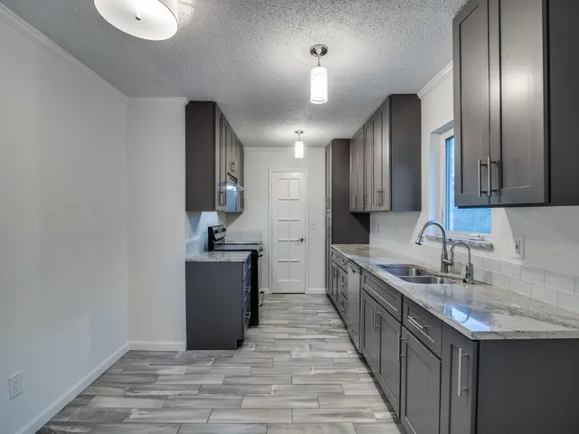 a kitchen with a sink and refrigerator