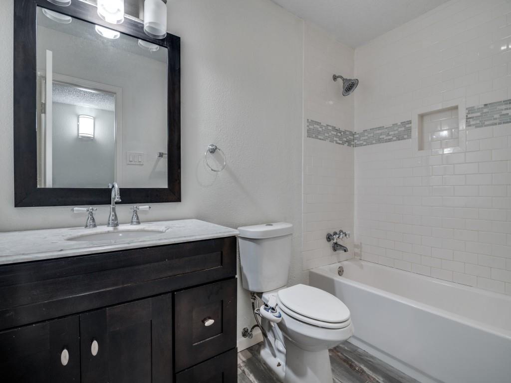 3425 Tarkio Road Plano, TX 75074 - Photo 16 of 25 a bathroom with a sink a toilet and shower
