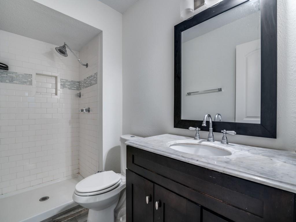 3425 Tarkio Road Plano, TX 75074 - Photo 20 of 25 a bathroom with a granite countertop sink toilet and shower