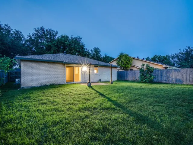 a view of a backyard with grass and a plants