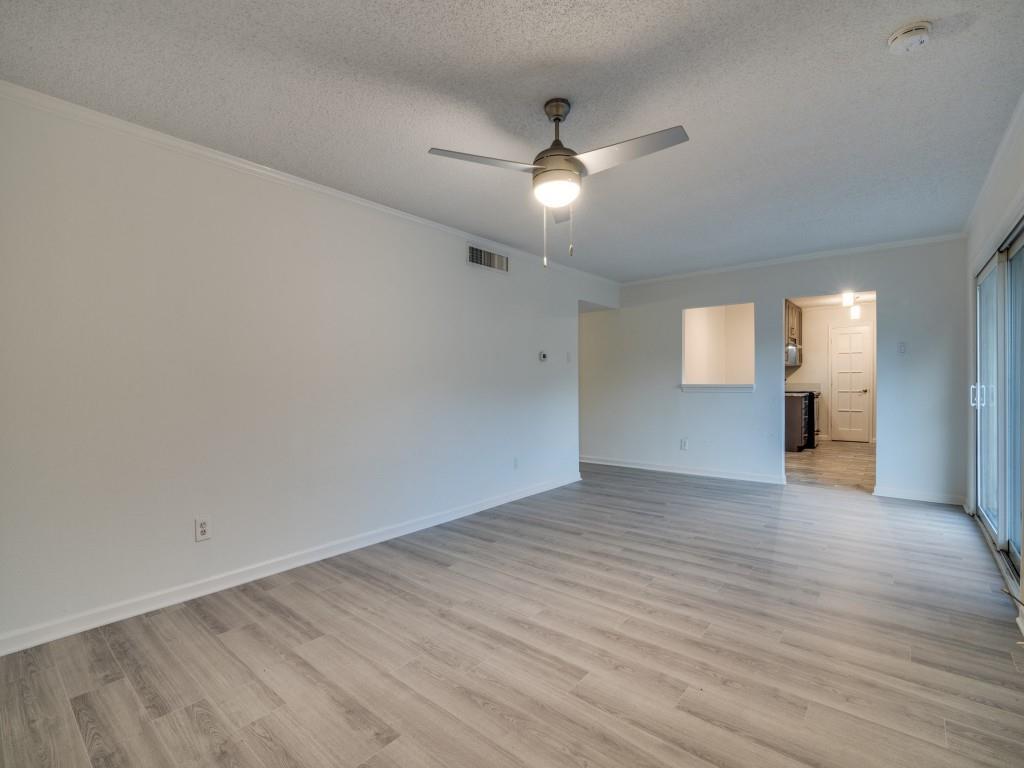 3425 Tarkio Road Plano, TX 75074 - Photo 8 of 25 an empty room with wooden floor fan and windows