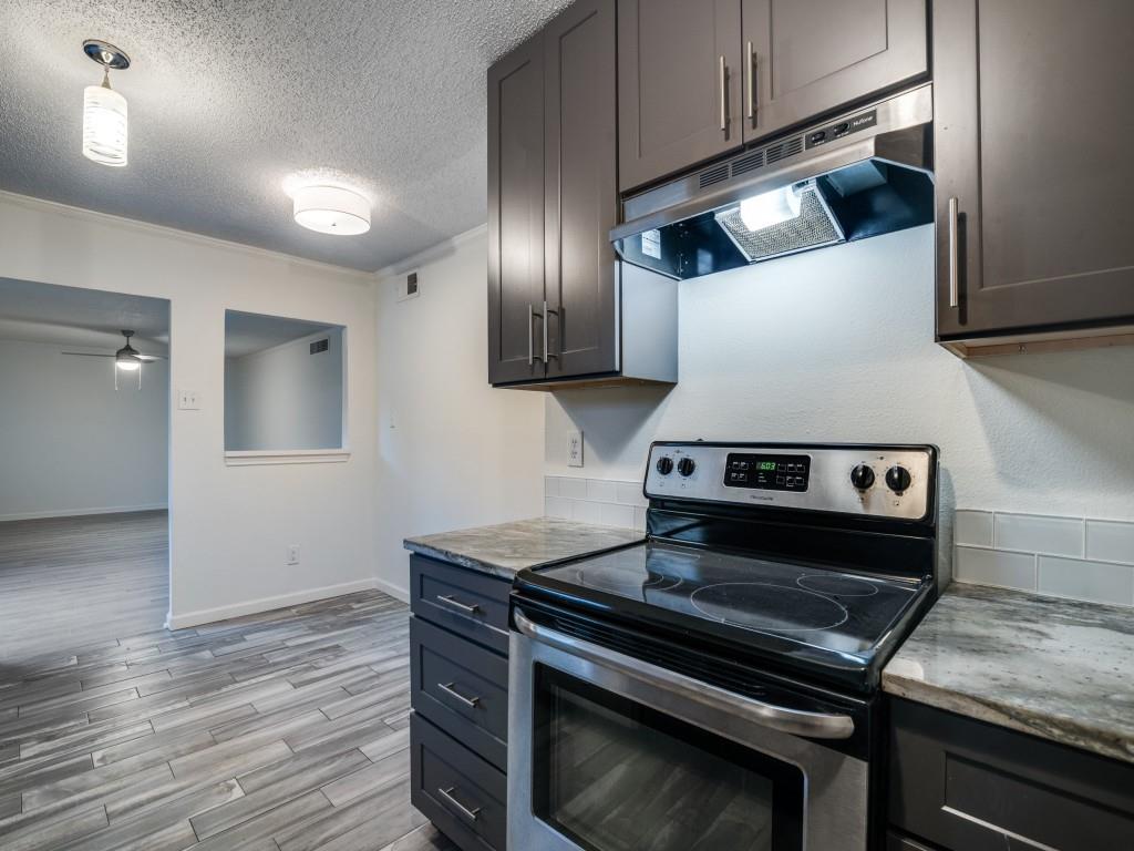 3425 Tarkio Road Plano, TX 75074 - Photo 10 of 25 a stove top oven sitting inside of a kitchen