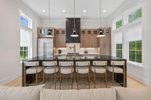 a kitchen with stainless steel appliances kitchen island granite countertop a sink and cabinets
