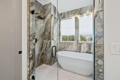 a bathroom with a bathtub and a shower