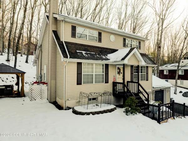 a front view of a house with a yard outdoor seating and pathway