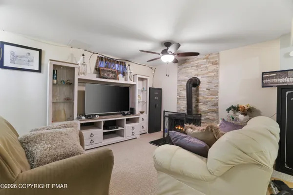 a living room with furniture and a gym machine