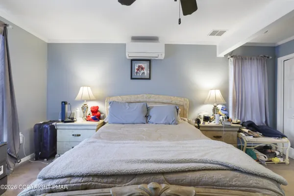 a bedroom with a bed and a flat screen tv