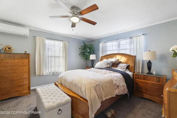 a bedroom with a bed and a dresser