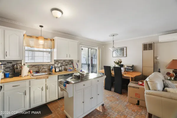 a kitchen with a sink a stove and cabinets