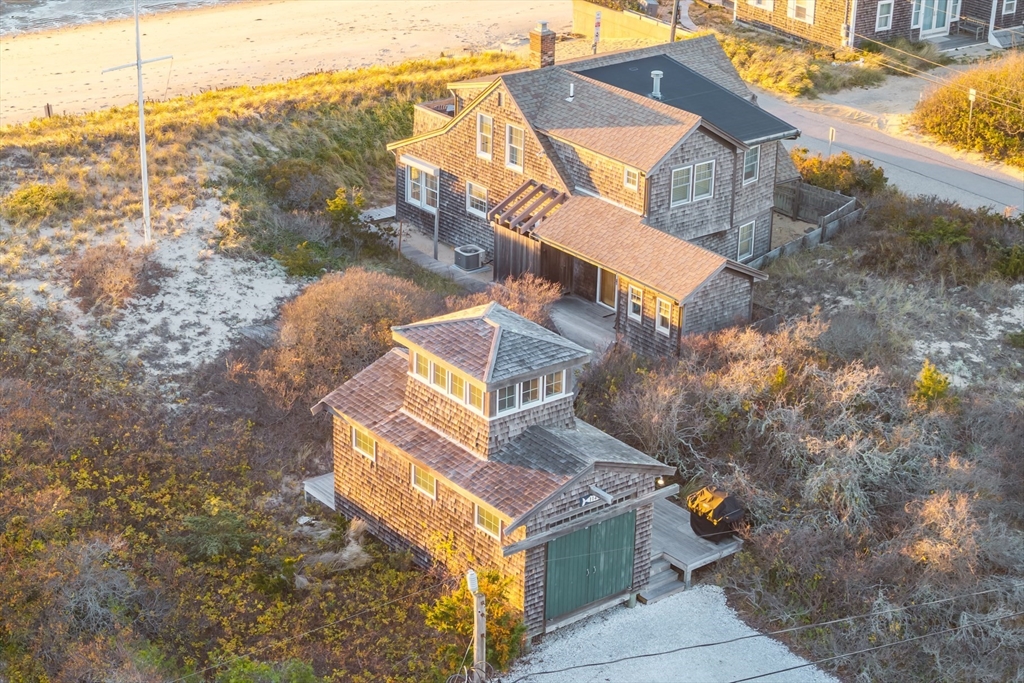 1145 Kingsbury Beach Road Eastham, MA 02642 - Photo 5 of 42 a view of a house with a dry yard