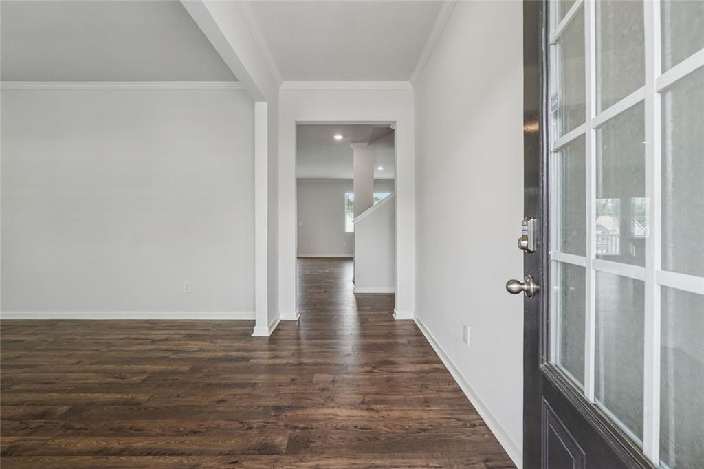 96 Quail Bend Way Dallas, GA 30157 - Photo 10 of 57 a view of a hallway with wooden floor and staircase