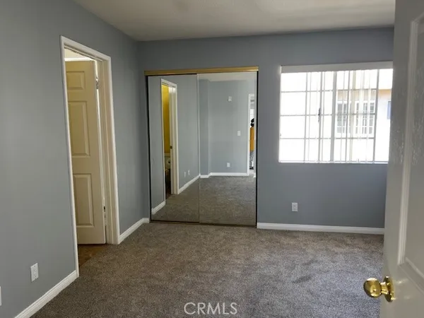 an empty room with windows and closet