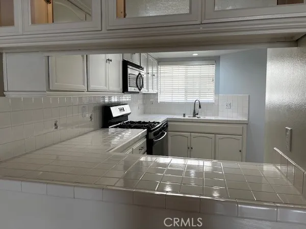 a kitchen with a sink and cabinets