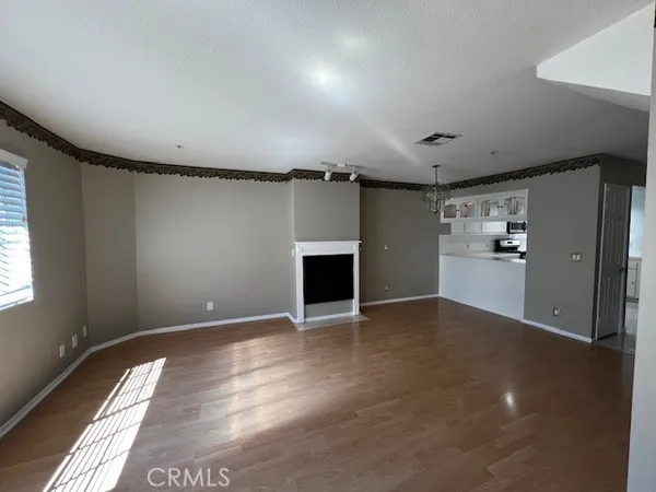 a view of a livingroom with a fireplace and window