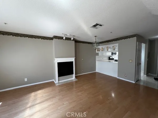 a view of an empty room with a fireplace