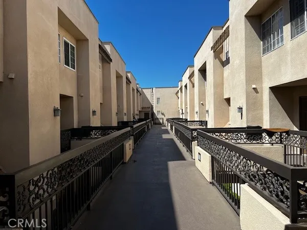 a view of two chairs and a table in the balcony