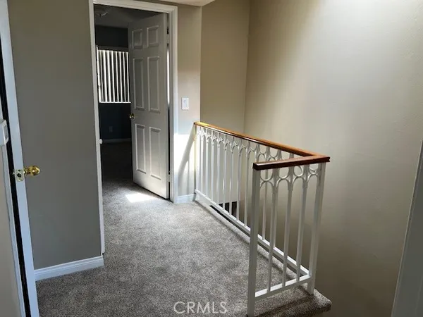 a view of a hallway with entryway door