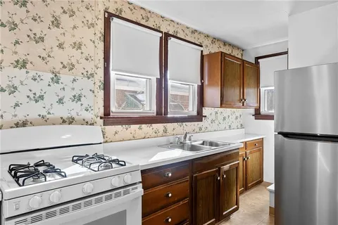 a kitchen with a sink stove and refrigerator