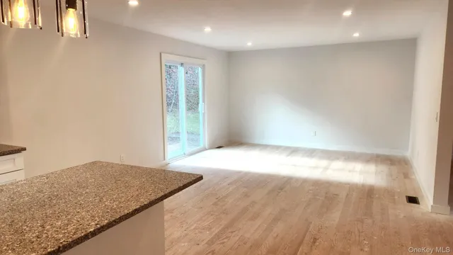 an empty room with wooden floor