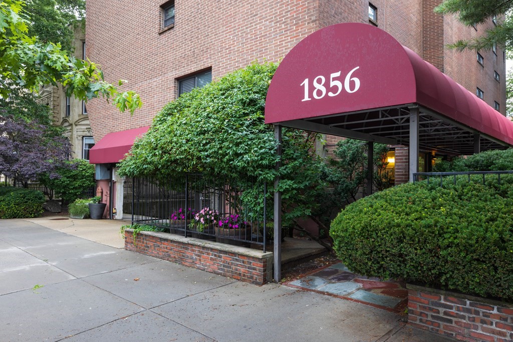 1856 Beacon Street, Unit PHA Brookline, MA 02445 - Photo 1 of 12 a sign on the side of a building