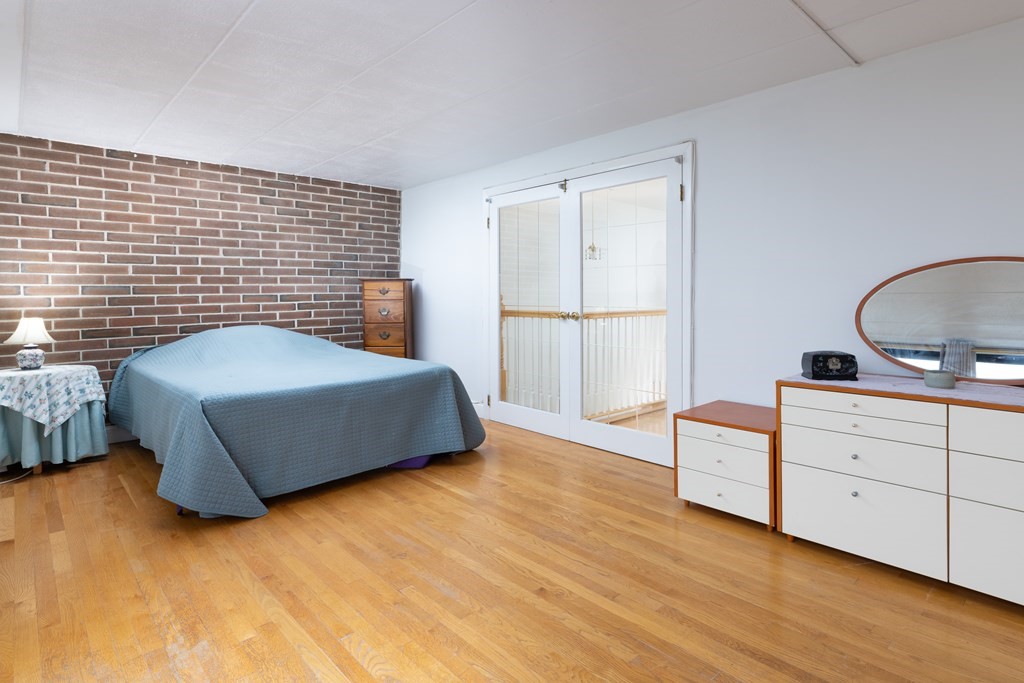 1856 Beacon Street, Unit PHA Brookline, MA 02445 - Photo 11 of 12 a bedroom with a bed and a dresser