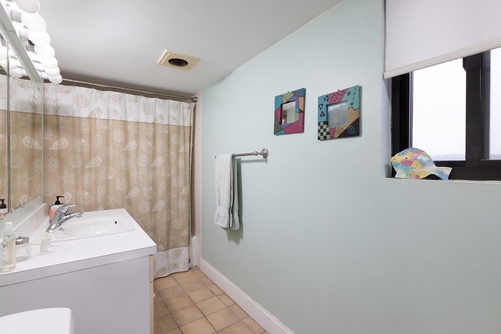 1856 Beacon Street, Unit PHA Brookline, MA 02445 - Photo 12 of 12 a bathroom with a tub sink and mirror