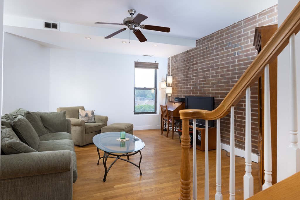 1856 Beacon Street, Unit PHA Brookline, MA 02445 - Photo 2 of 12 a living room with furniture and a large window