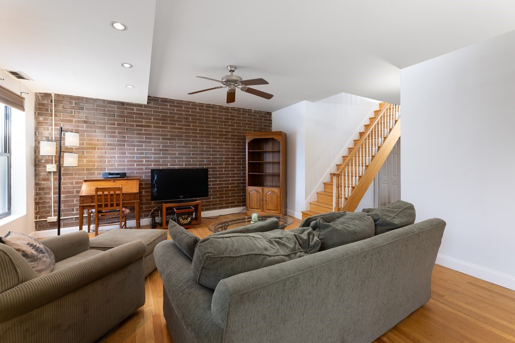 1856 Beacon Street, Unit PHA Brookline, MA 02445 - Photo 3 of 12 a living room with furniture and a fireplace