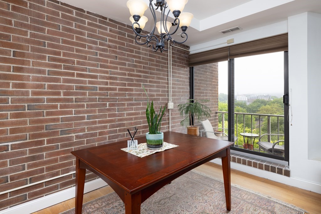 1856 Beacon Street, Unit PHA Brookline, MA 02445 - Photo 4 of 12 a view of a dining room with furniture window and outside view