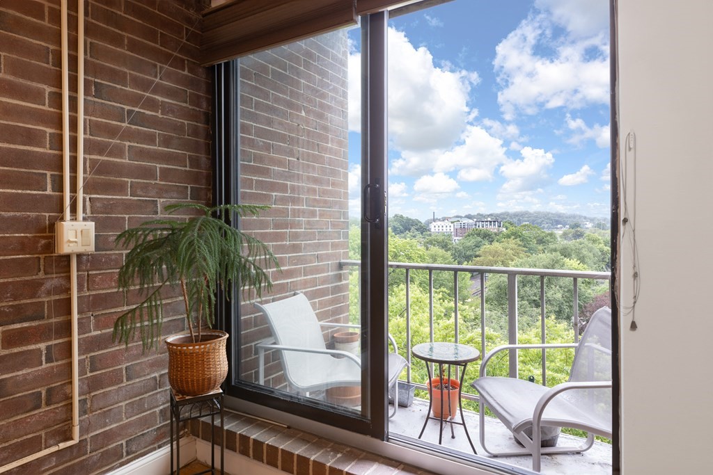 1856 Beacon Street, Unit PHA Brookline, MA 02445 - Photo 6 of 12 a view of a balcony with chair and glass door