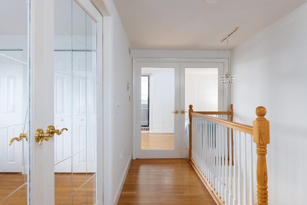 1856 Beacon Street, Unit PHA Brookline, MA 02445 - Photo 8 of 12 a view of a hallway view with wooden staircase