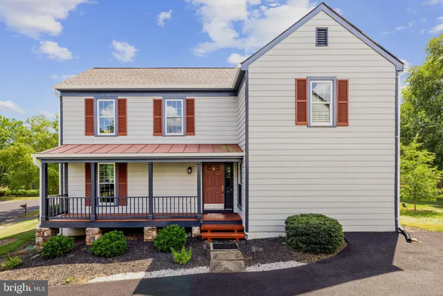 a living room with furniture a rug and a large window
