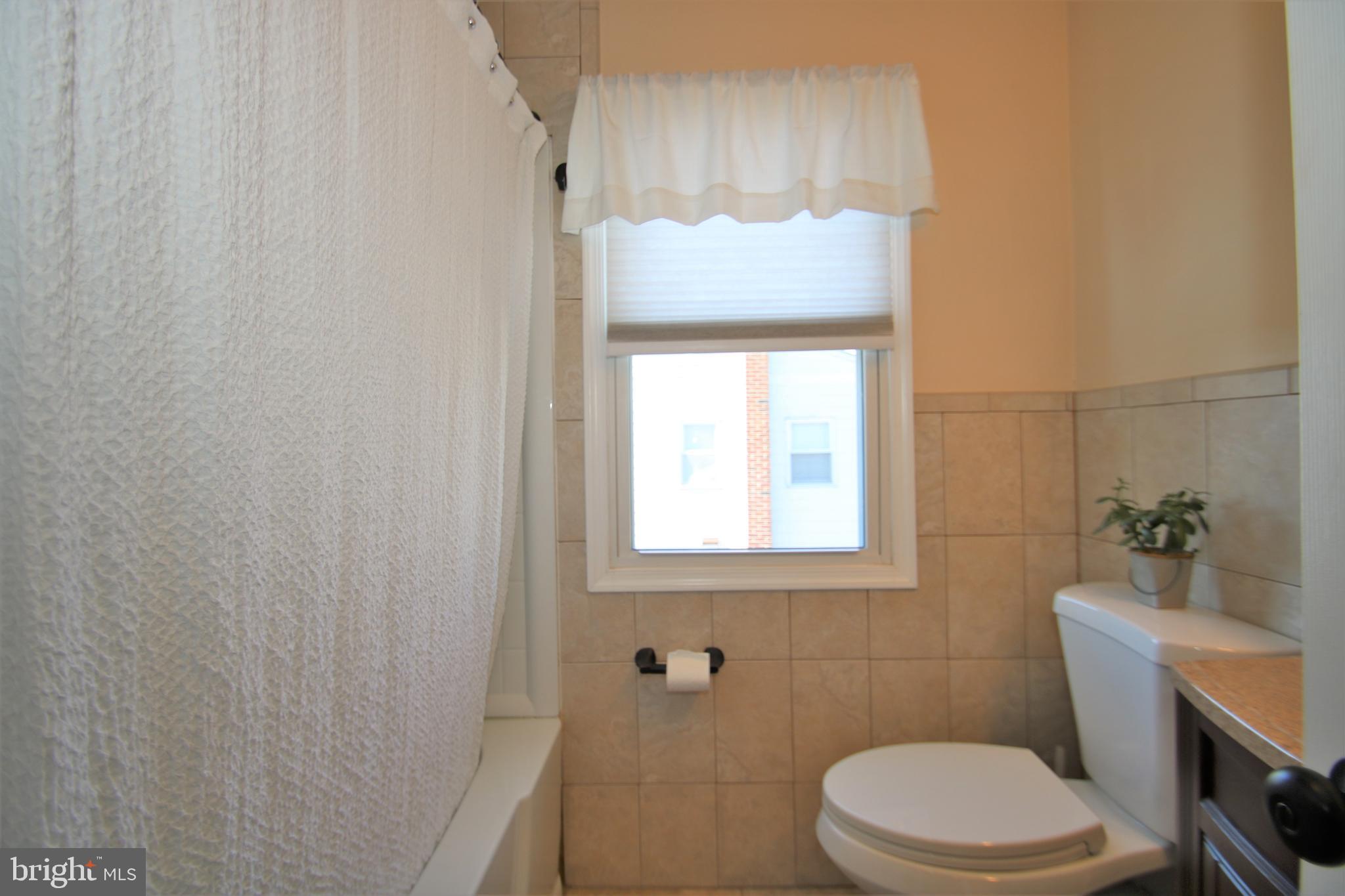 1421 Blackrock Road Swarthmore, PA 19081 - Photo 22 of 41 a white toilet sitting next to a bathroom sink and vanity